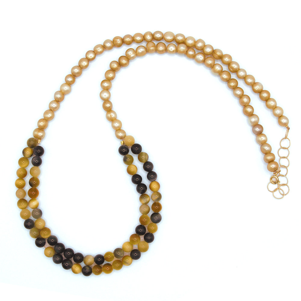 These silky, warm-toned silky freshwater pearls lead into an alluring double strand of blue and gold tiger’s eye, with a bit of gold-filled chain at the ends to make the necklace adjustable. Handmade by Abracadabra exclusive artist MOROKA, a mother/daughter/daughter team committed to creating beautiful jewelry for all.