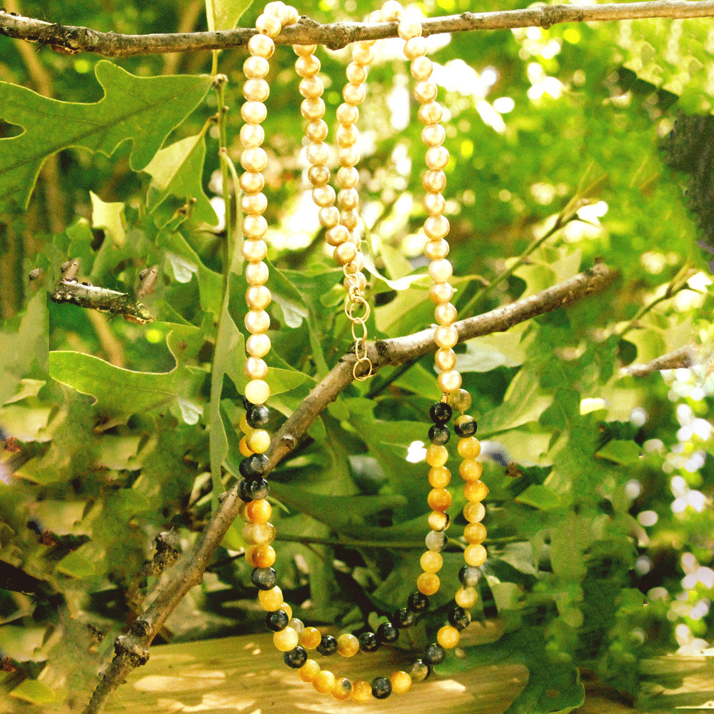 These silky, warm-toned silky freshwater pearls lead into an alluring double strand of blue and gold tiger’s eye, with a bit of gold-filled chain at the ends to make the necklace adjustable. Handmade by Abracadabra exclusive artist MOROKA, a mother/daughter/daughter team committed to creating beautiful jewelry for all.