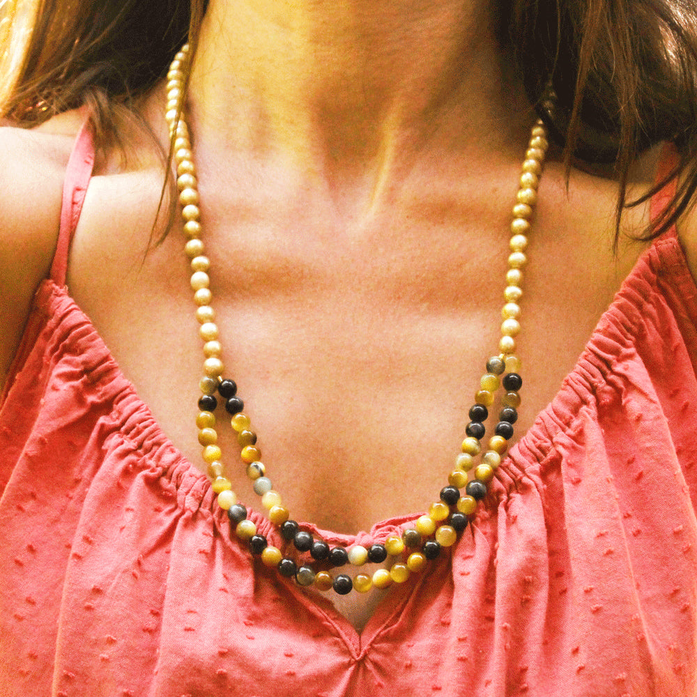 These silky, warm-toned silky freshwater pearls lead into an alluring double strand of blue and gold tiger’s eye, with a bit of gold-filled chain at the ends to make the necklace adjustable. Handmade by Abracadabra exclusive artist MOROKA, a mother/daughter/daughter team committed to creating beautiful jewelry for all.