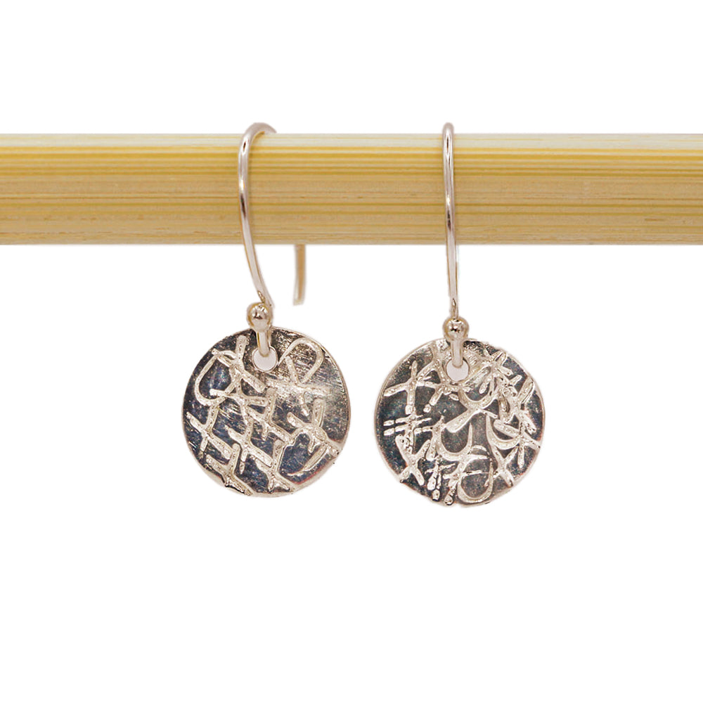 A sweet sentiment with a classy, casual vibe, these sterling silver earrings are each handcrafted and individually stamped. Handmade by Abracadabra exclusive artist MOROKA, a mother/daughter/daughter team committed to creating beautiful jewelry for all.