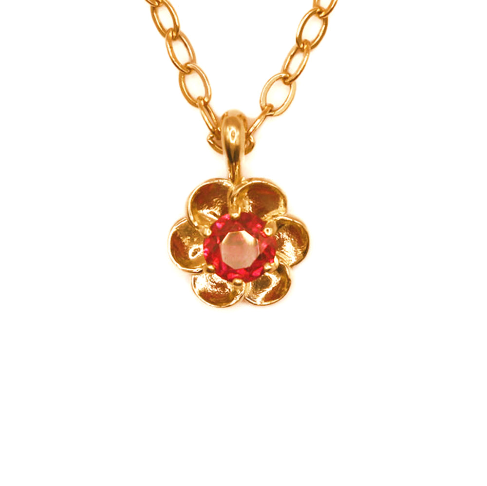 This 14k yellow gold buttercup pendant, set with a dazzling red rhodolite garnet, is rich in color and as fresh as a spring day.