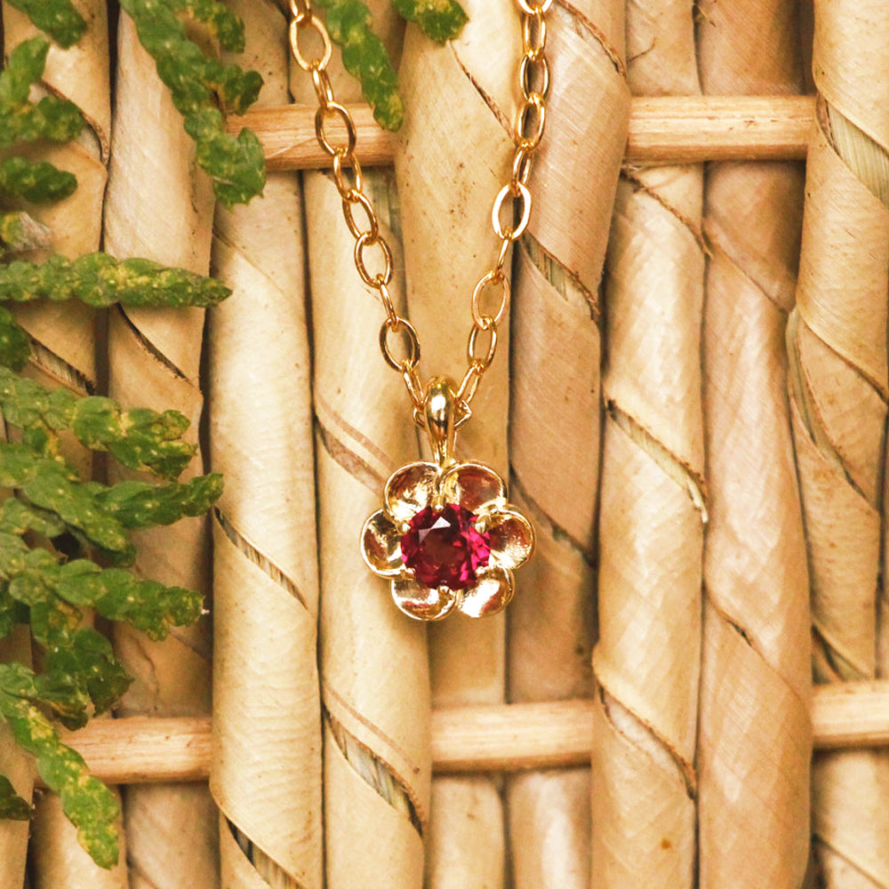 This 14k yellow gold buttercup pendant, set with a dazzling red rhodolite garnet, is rich in color and as fresh as a spring day.